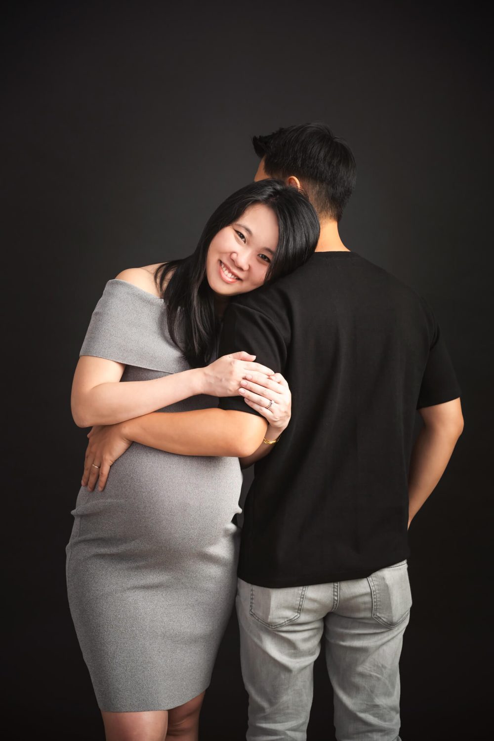 Expectant mother embracing her partner during a maternity couple photoshoot